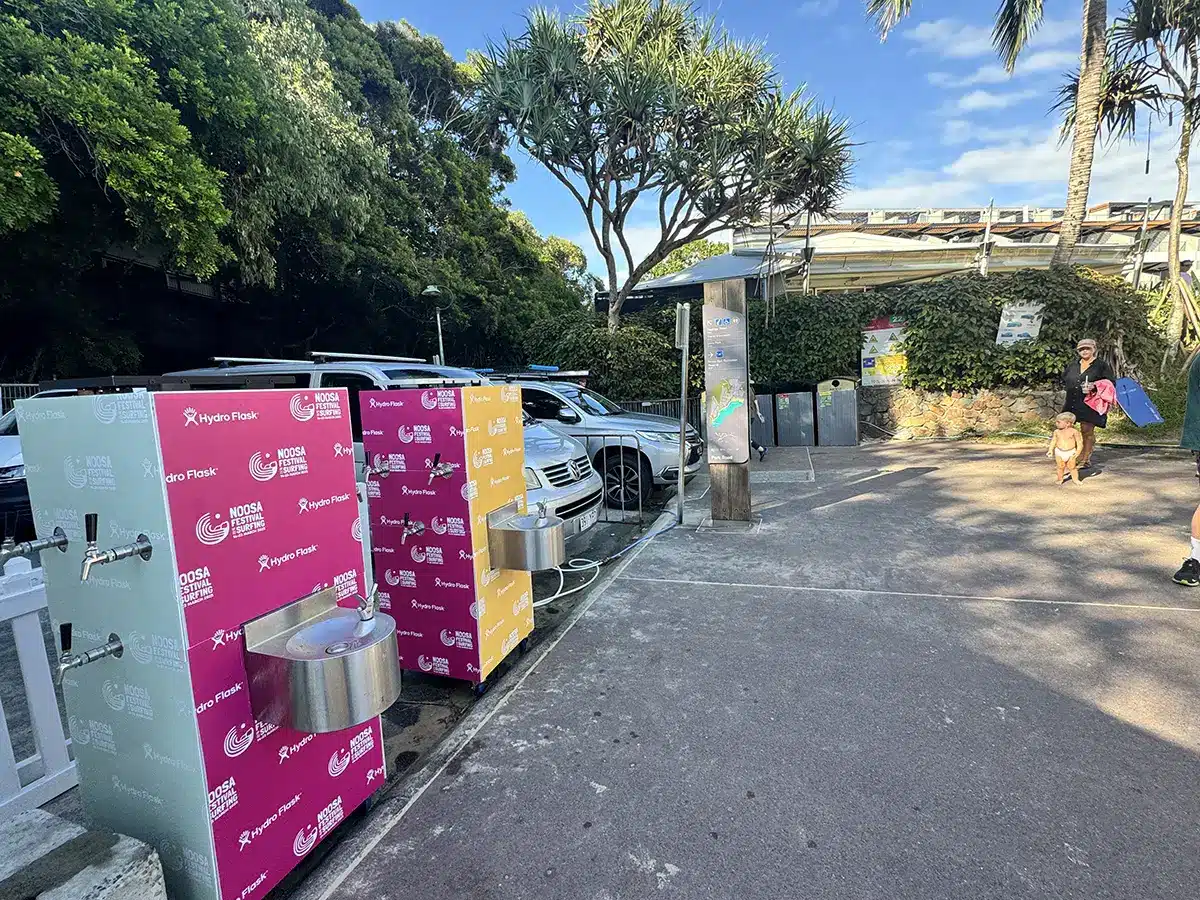 Eco-friendly branded water trailer serving filtered water at outdoor event.