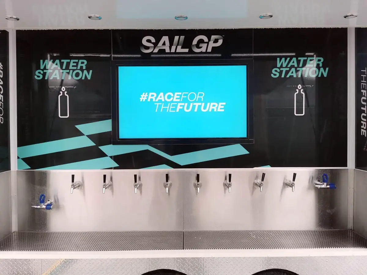 Digital screen display on hydration trailer showing dynamic ad content.