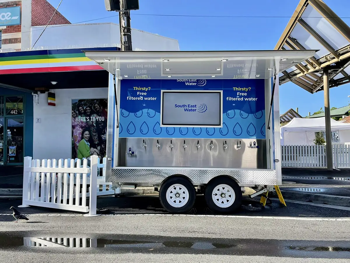 Multi-tap water trailer with full branding setup for corporate event.